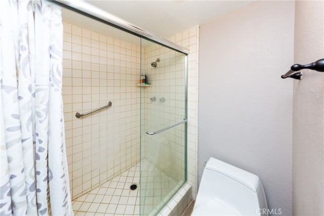 full bathroom with a stall shower and toilet