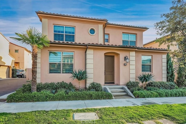 mediterranean / spanish-style house featuring stucco siding and a tile roof