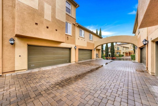 garage featuring decorative driveway