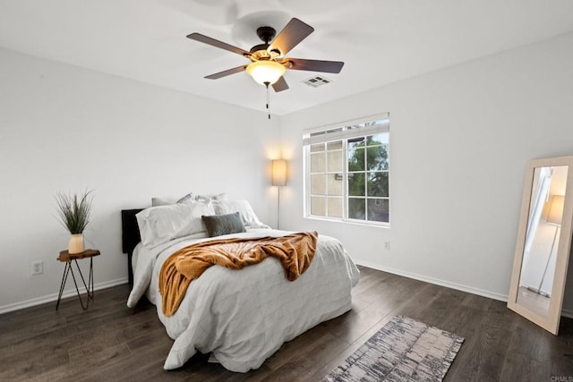 bedroom with a ceiling fan, dark wood-type flooring, visible vents, and baseboards