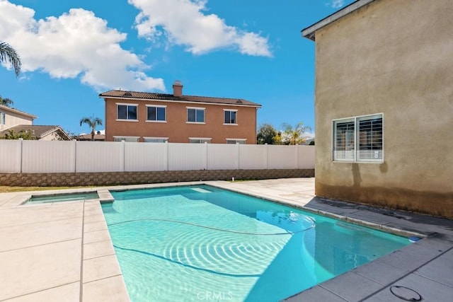 view of pool featuring a patio area, a fenced in pool, and fence