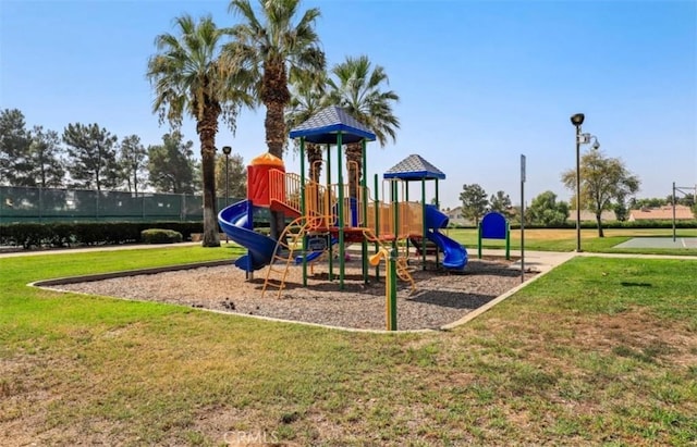 community jungle gym featuring a yard