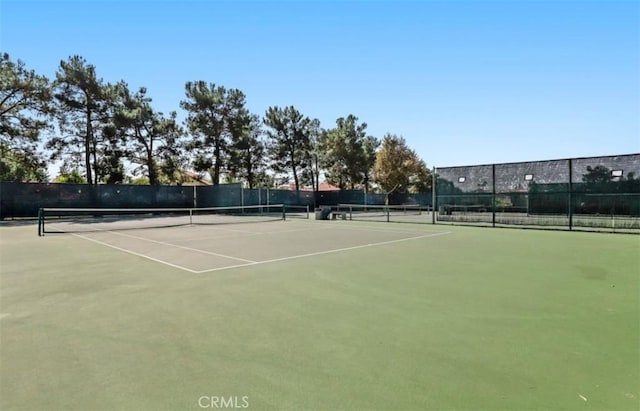 view of tennis court with fence