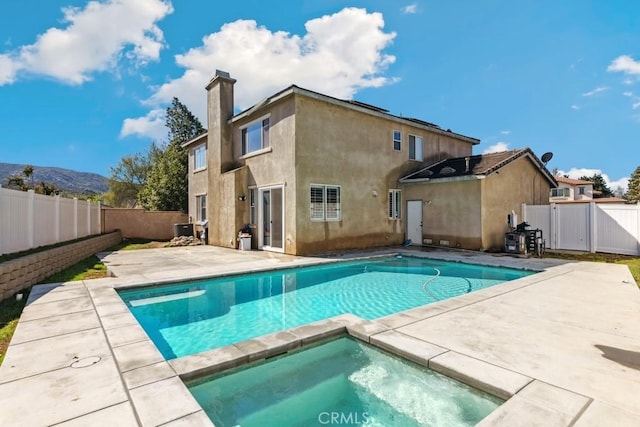 view of pool with a fenced in pool, a fenced backyard, an in ground hot tub, a patio, and a gate