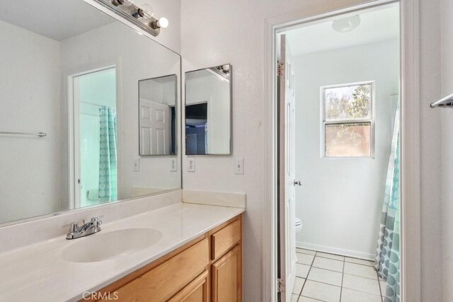 full bath featuring tile patterned floors, toilet, and vanity