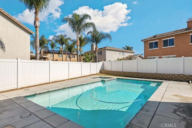 view of pool with a patio, a fenced backyard, and a pool with connected hot tub