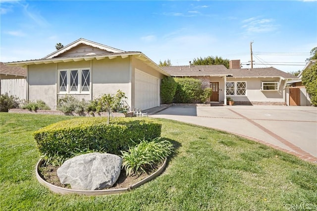 single story home with a front lawn, fence, and stucco siding