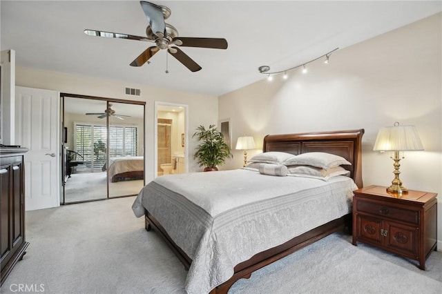 bedroom with access to exterior, a ceiling fan, visible vents, and light carpet