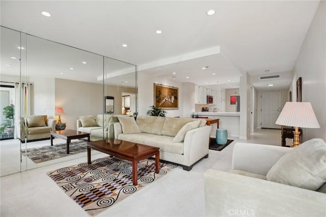 living area featuring recessed lighting and visible vents