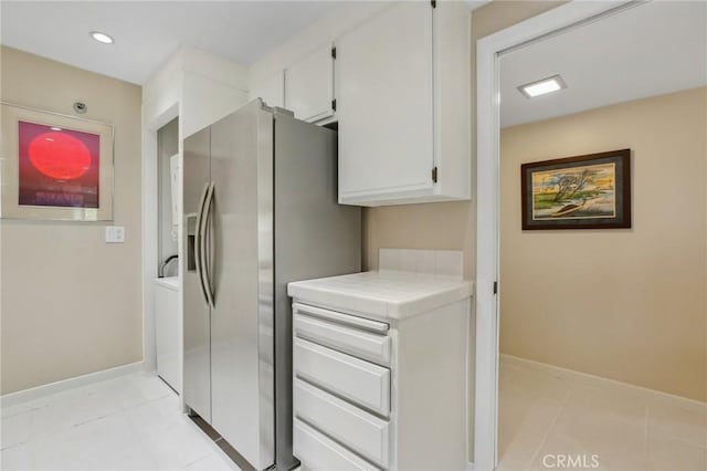 laundry room with recessed lighting, baseboards, and light tile patterned flooring