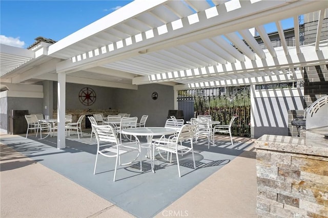 view of patio / terrace featuring a pergola and outdoor dining area