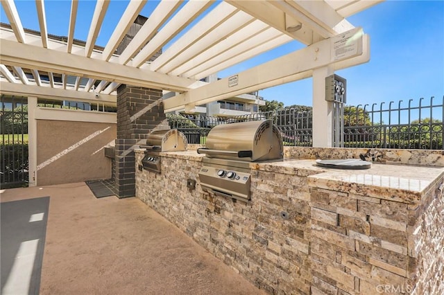 view of patio featuring area for grilling and fence