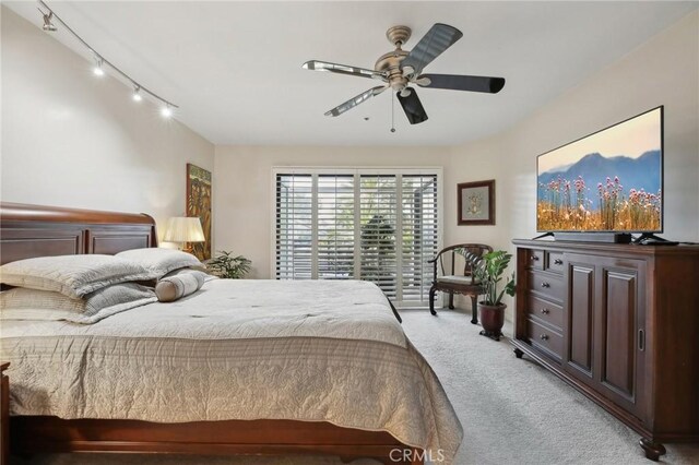 bedroom featuring light carpet and a ceiling fan