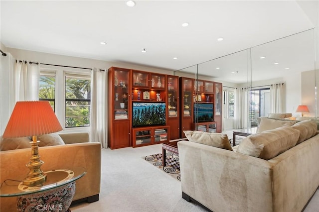 living room featuring recessed lighting and light colored carpet