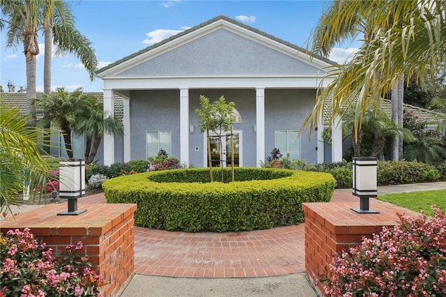 view of front facade with french doors and stucco siding