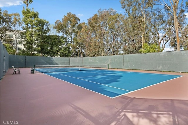 view of sport court featuring fence