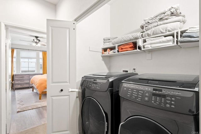 laundry area with wood finished floors, separate washer and dryer, ceiling fan, and laundry area