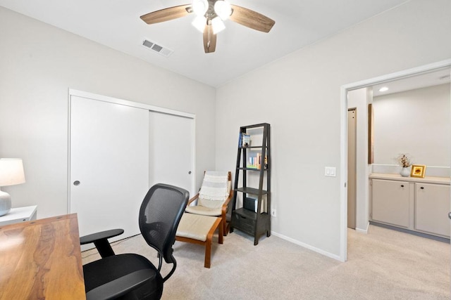 home office featuring visible vents, light colored carpet, baseboards, and ceiling fan