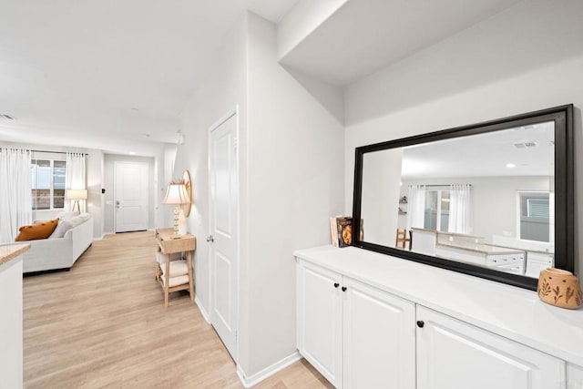 interior space featuring visible vents, baseboards, and light wood-style floors