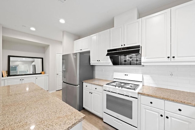 kitchen featuring stainless steel fridge with ice dispenser, under cabinet range hood, white gas range, decorative backsplash, and white cabinetry