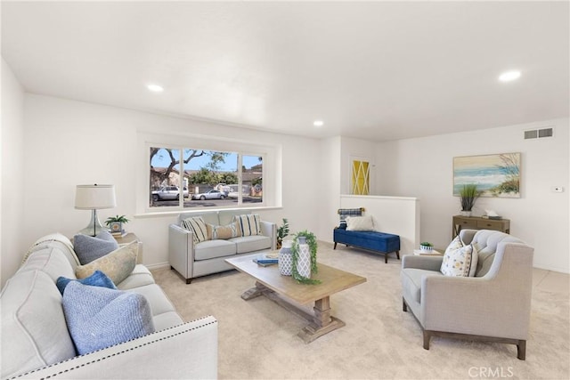 living room with recessed lighting, light colored carpet, visible vents, and baseboards