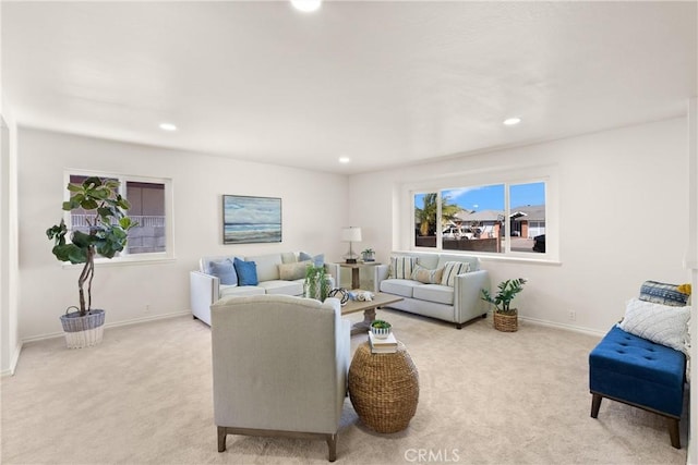 living room with recessed lighting, light colored carpet, and baseboards