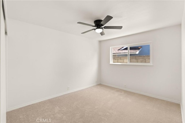 carpeted empty room with baseboards and ceiling fan