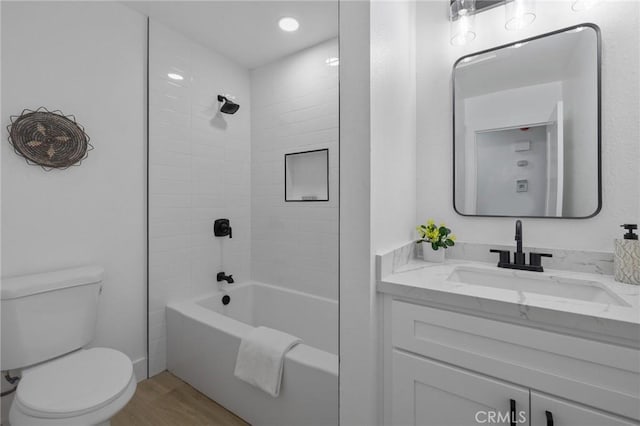 bathroom with vanity, shower / tub combination, toilet, and wood finished floors