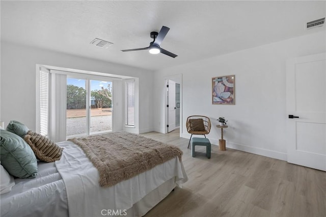 bedroom featuring visible vents, light wood-type flooring, and baseboards