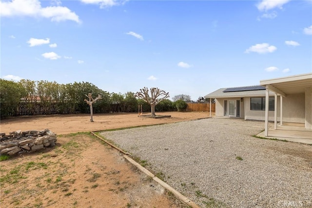 view of yard featuring french doors, a patio, and a fenced backyard