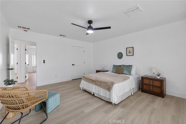 bedroom with baseboards, visible vents, and light wood-type flooring