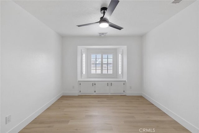 unfurnished room with visible vents, ceiling fan, baseboards, and light wood-style floors