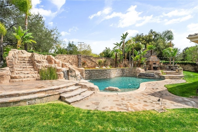 view of pool featuring a patio, fence, and an outdoor stone fireplace