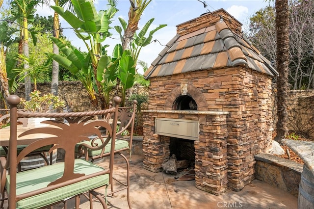 view of patio with an outdoor stone fireplace