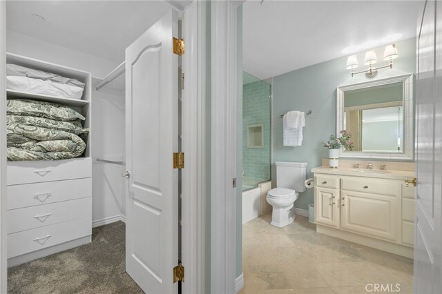 full bath featuring toilet, vanity, baseboards, and washtub / shower combination