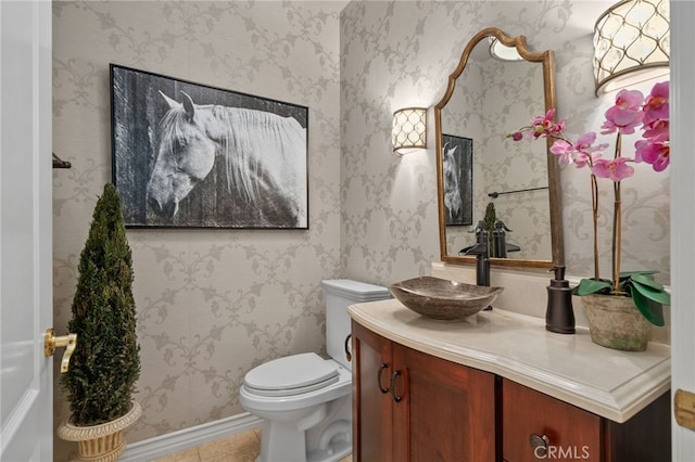 bathroom featuring wallpapered walls, tile patterned floors, toilet, and vanity