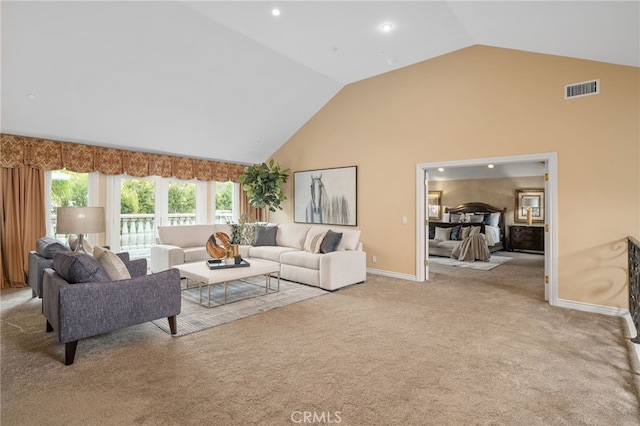 living room featuring baseboards, carpet, visible vents, and high vaulted ceiling