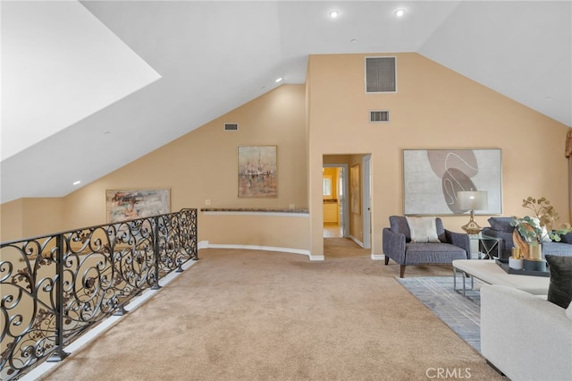 interior space with visible vents, baseboards, and high vaulted ceiling