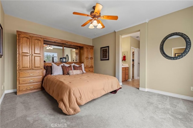 bedroom featuring a ceiling fan, light colored carpet, baseboards, and connected bathroom