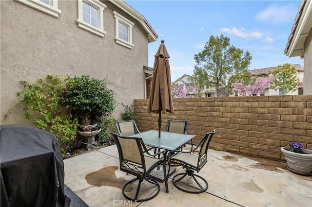 view of patio / terrace featuring area for grilling, outdoor dining space, and fence