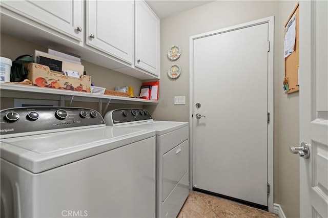 laundry room featuring washer and clothes dryer and cabinet space