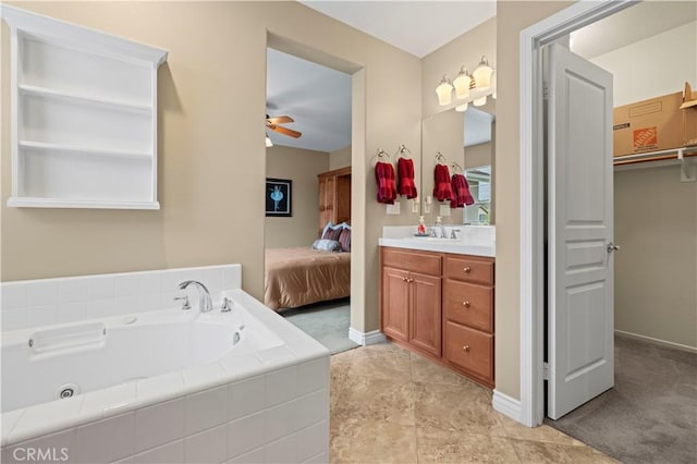 ensuite bathroom featuring a ceiling fan, ensuite bath, baseboards, a bath, and vanity