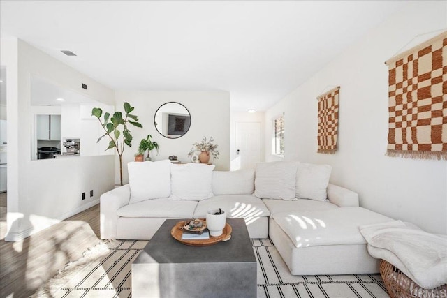 living room with visible vents and wood finished floors