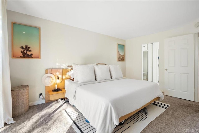 bedroom featuring carpet and baseboards