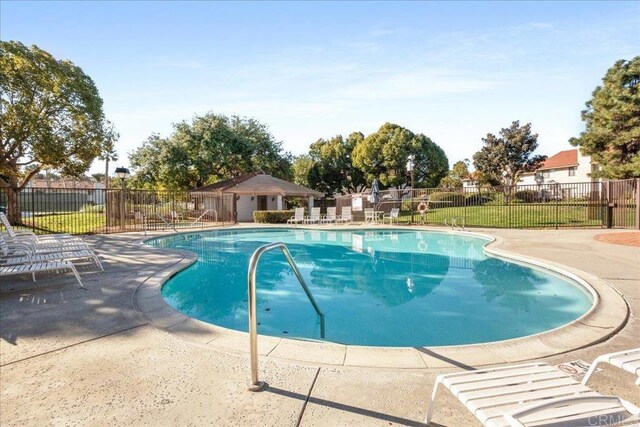 community pool featuring a patio and fence