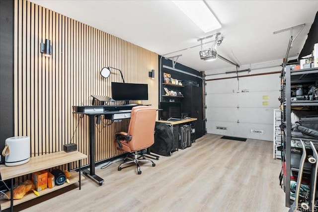 office with wood finished floors and a garage