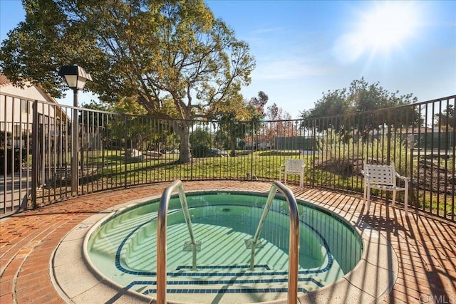 view of pool featuring a community hot tub and fence