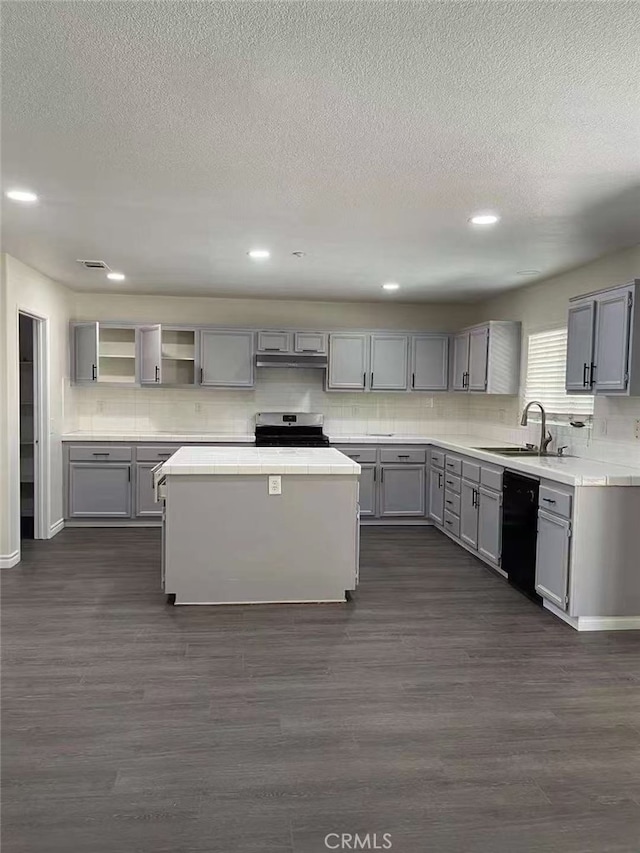 kitchen featuring tile countertops, stainless steel electric stove, gray cabinets, a sink, and dishwasher