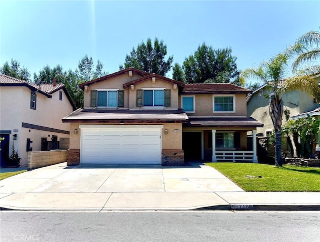 view of front facade featuring brick siding, concrete driveway, a front yard, stucco siding, and a garage