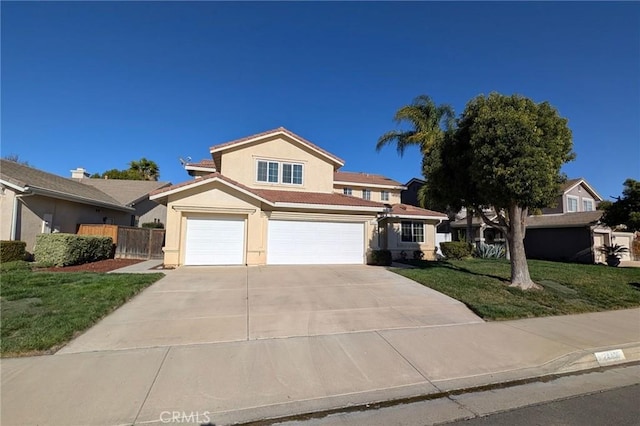 traditional home featuring stucco siding, driveway, fence, a front yard, and a tiled roof